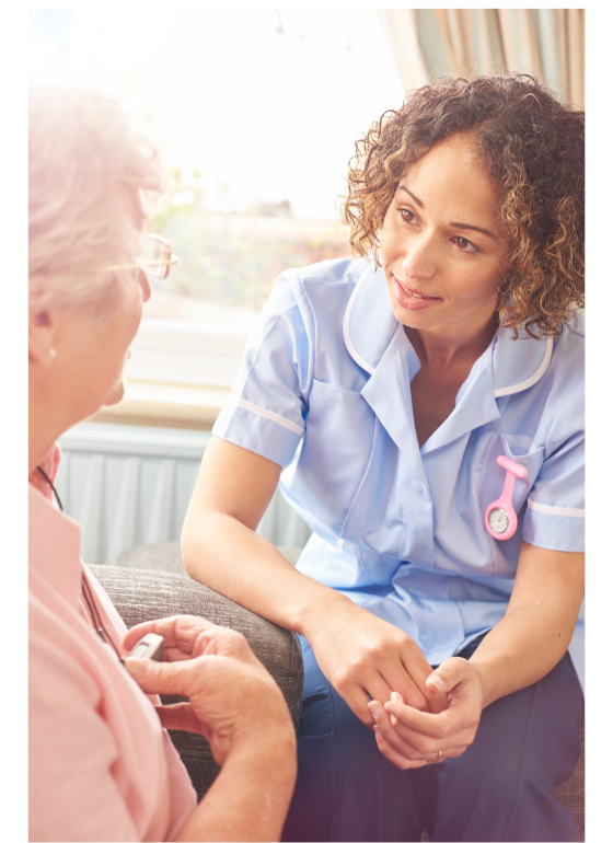 Compassionate care giver listening to elderly lady